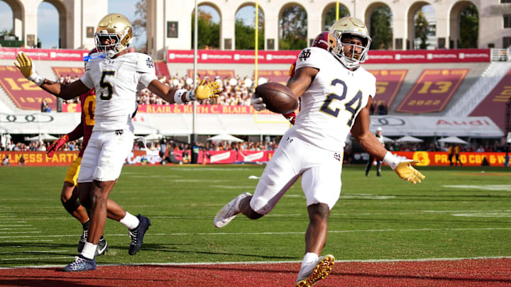 Nov 30, 2024; Los Angeles, California, USA; Notre Dame Fighting Irish running back Jadarian Price (24) scores on a 36-yard touchdown run against the Southern California Trojans in the second half at United Airlines Field at Los Angeles Memorial Coliseum. Mandatory Credit: Kirby Lee-Imagn Images