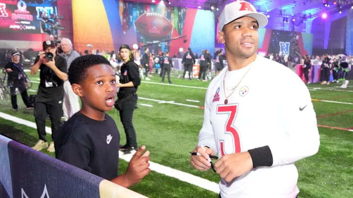 AFC quarterback Russell Wilson (3) and son react during the Pro Bowl Skills Challenge at Nicholson Fieldhouse.