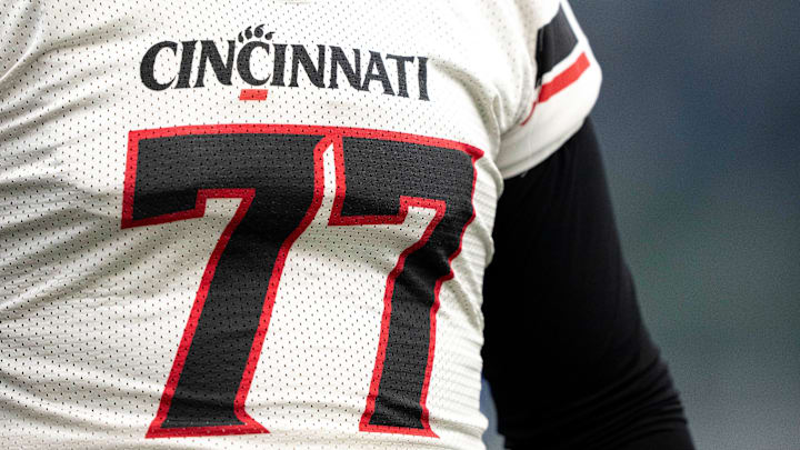 Cincinnati Bearcats offensive lineman Taran Tyo (77) smiles during football practice at Sheakley Athletic Performance Center in Cincinnati on Dec. 18, 2025.