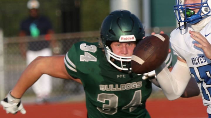 Flagler Palm Coast's Colby Cronk #34 zeros in on Deltona High QB Jermiah Hancock #15, Friday August 16, 2024 in Palm Coast.