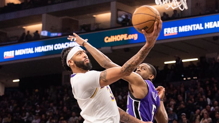 Dec 21, 2024; Sacramento, California, USA; Los Angeles Lakers forward Anthony Davis (3) puts up a shot against Sacramento Kings guard De'Aaron Fox (5) during the second quarter at Golden 1 Center. Mandatory Credit: Ed Szczepanski-Imagn Images