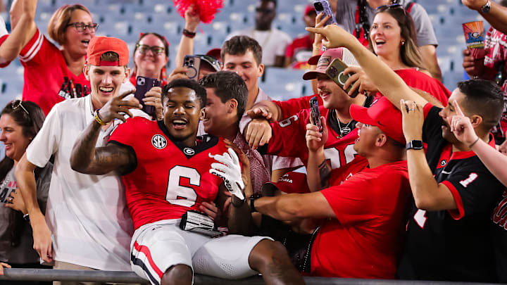 Georgia Bulldogs wide receiver Dominic Lovett (6) is hugged by fans at EverBank Stadium in Jacksonville, FL on Saturday, November 2, 2024. The Bulldogs defeated the Gators 34-20. [Doug Engle/Gainesville Sun]