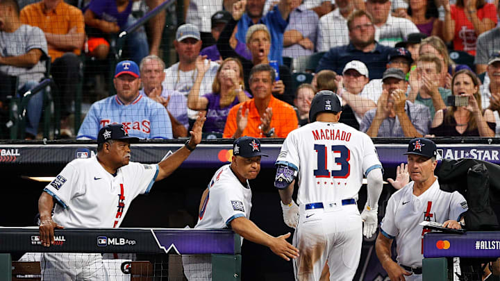 Jul 13, 2021; Denver, Colorado, USA; National League third baseman Manny Machado of the San Diego Padres (13) is congratulated after scoring against the American League by honorary coach Reggie Smith (left) and manager Dave Roberts of the Los Angeles Dodgers (center) during the sixth inning during the 2021 MLB All Star Game at Coors Field. Mandatory Credit: Isaiah J. Downing-Imagn Images
