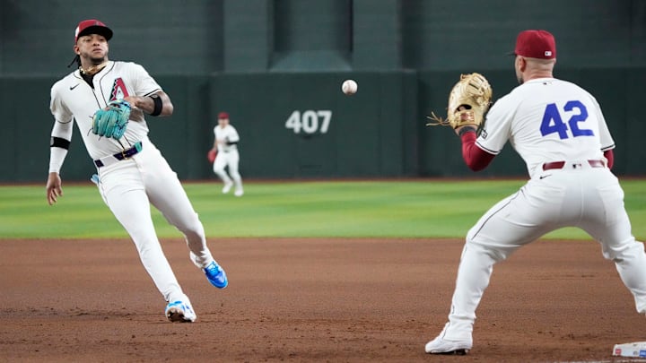 Arizona Diamondbacks second baseman Ketel Marte (42) tosses the ball to first baseman Christian Walker (42) during the fourth inning against the Chicago Cubs at Chase Field in Phoenix on April 15, 2024. All players are wearing number 42 in honor of Jackie Robinson Day. Arizona Diamondbacks second baseman Ketel Marte (42) tosses the ball to first baseman Christian Walker (42) during the fourth inning against the Chicago Cubs at Chase Field in Phoenix on April 15, 2024. All players are wearing number 42 in honor of Jackie Robinson Day.