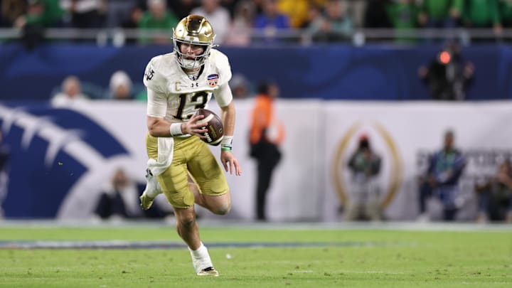 Jan 9, 2025; Miami, FL, USA; Notre Dame Fighting Irish quarterback Riley Leonard (13) runs the ball in the second half against the Penn State Nittany Lions  in the Orange Bowl at Hard Rock Stadium. Mandatory Credit: Nathan Ray Seebeck-Imagn Images