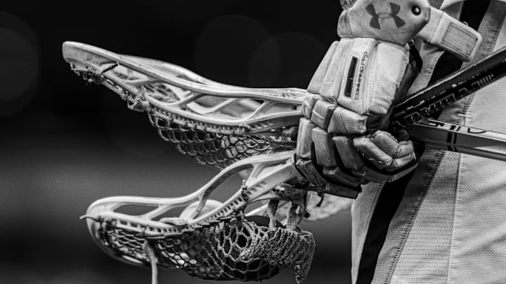 May 27, 2024; Philadelphia, PA, USA; (photo converted to black and white) Notre Dame fighting Irish player holds gloves and lacrosse sticks before a game against the Maryland Terrapins at Lincoln Financial Field. Mandatory Credit: Bill Streicher-Imagn Images May 27, 2024; Philadelphia, PA, USA; (photo converted to black and white) Notre Dame fighting Irish player holds gloves and lacrosse sticks before a game against the Maryland Terrapins at Lincoln Financial Field. Mandatory Credit: Bill Streicher-Imagn Images