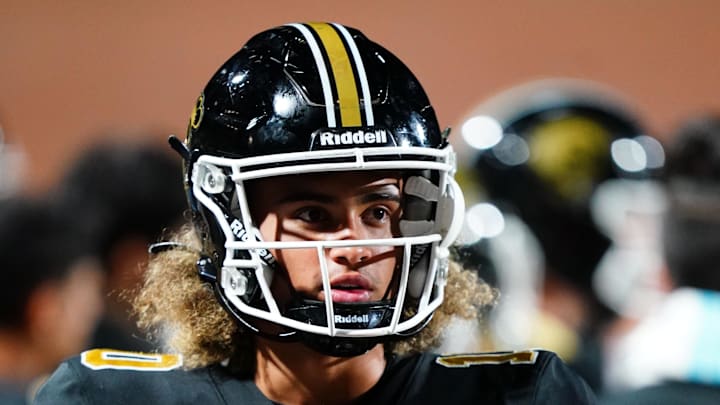 Oct 20, 2023; Carrollton, GA, USA; Carrollton Trojans quarterback Julian Lewis (10) watches on from the sidelines against the Westlake Lions during the first half at Grisham Stadium. The 15-year-old Carrollton High student has already committed to playing for the University of Southern California Trojans and has been considered one of the top high school quarterback prospects. Mandatory Credit: John David Mercer-Imagn Images
