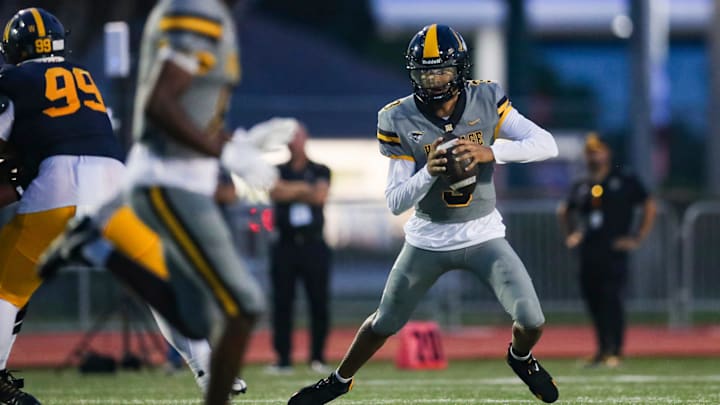 American Heritage Patriots quarterback Dia Bell (3) scrambles in the backfield during the first quarter of a game against the Naples Golden Eagles at Staver Field in Naples on Friday, Sept. 13, 2024.