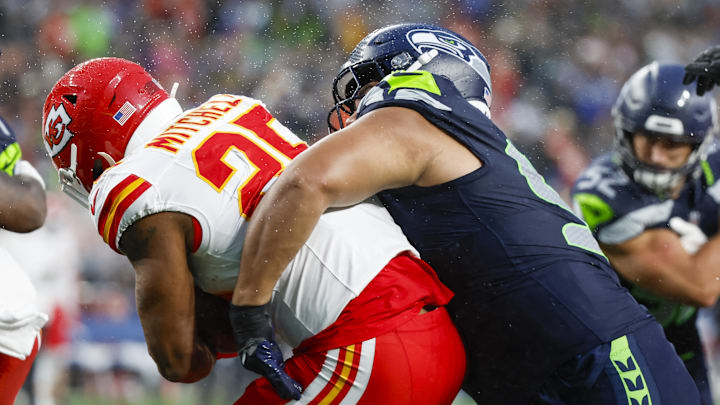 Aug 15, 2025; Seattle, Washington, USA; Seattle Seahawks defensive tackle Brandon Pili (95) tackles Kansas City Chiefs running back Elijah Mitchell (25) in the end zone for a safety during the second quarter at Lumen Field. Mandatory Credit: Joe Nicholson-Imagn Images