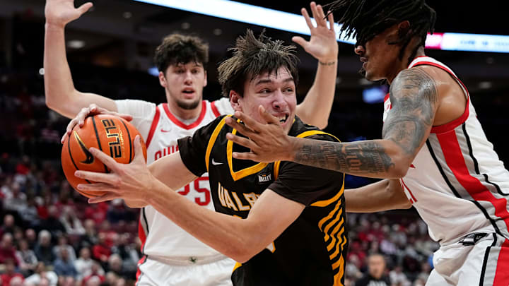 Ohio State Buckeyes forward Devin Royal (21) defends Valparaiso Beacons forward Cooper Schwieger (13) during the during the first half of the NCAA men's basketball game at Value City Arena in Columbus on Dec. 17, 2024.