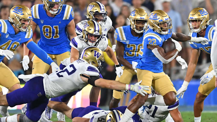 UCLA running back Keegan Jones (22) tried to avoid UW tackler Carson Bruener in the 2022 game.