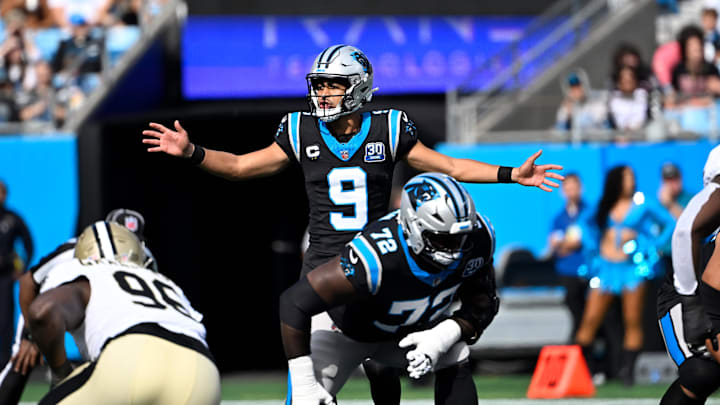 Nov 3, 2024; Charlotte, North Carolina, USA; Carolina Panthers quarterback Bryce Young (9) calls a play as offensive tackle Taylor Moton (72) looks on and New Orleans Saints defensive end Carl Granderson (96) prepares to defend in the first qarter at Bank of America Stadium. Mandatory Credit: Bob Donnan-Imagn Images