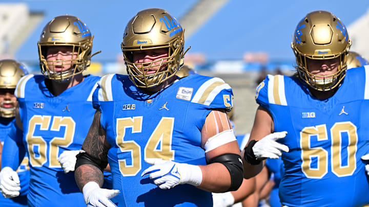 Nov 30, 2024; Pasadena, California, USA; UCLA Bruins offensive lineman Michael Sultemeier (62), Josh Carlin (54) and Jensen Somerville (60) during pregame warmups before playing Fresno State Bulldogs at Rose Bowl. Mandatory Credit: Robert Hanashiro-Imagn Images
