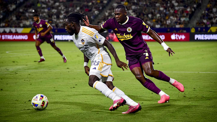 LA Galaxy forward Joseph Paintsil (28) and Portland Timbers defender Kamal Miller (4) battle for the ball during their MLS soccer match at Dignity Health Sports Park.  