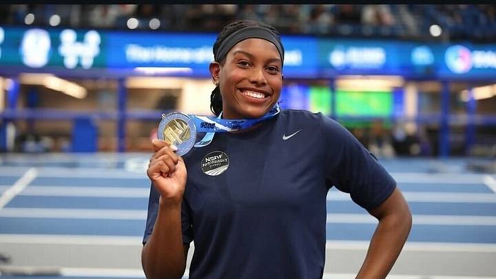 Jaslene Massey posing with her Nike Indoor Nationals first place medal after a historic and dominating performance.