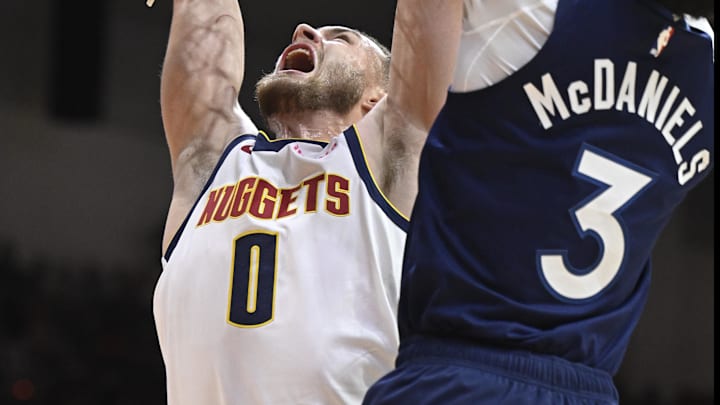 Oct 4, 2025; San Diego, California, USA; Denver Nuggets guard Christian Braun (0) tries to dunk over Minnesota Timberwolves forward Jaden McDaniels (3) during the first half at Pechanga Arena. Mandatory Credit: Denis Poroy-Imagn Images