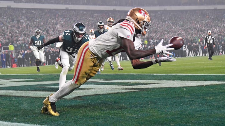 Dec 3, 2023; Philadelphia, Pennsylvania, USA; San Francisco 49ers wide receiver Brandon Aiyuk (11) catches touchdown pass against Philadelphia Eagles safety Reed Blankenship (32) during the second quarter at Lincoln Financial Field.