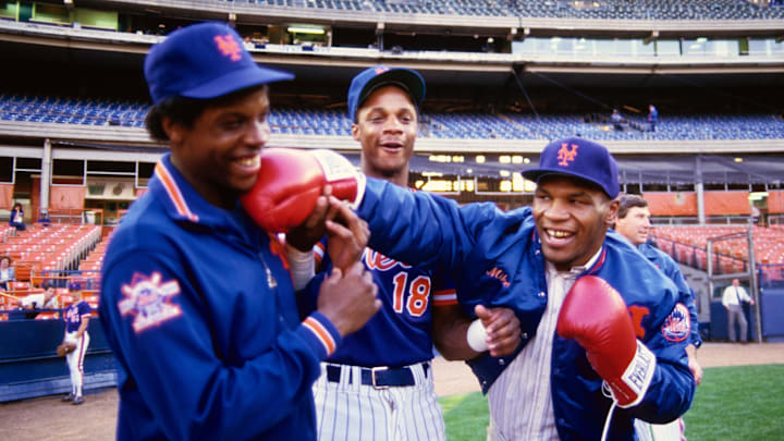 1990; Flushing, NY, USA; FILE PHOTO; New York Mets pitcher Dwight Gooden and right fielder Darryl Strawberry (18) joke around on the field with boxer Mike Tyson before a game at Shea Stadium. 1990; Flushing, NY, USA; FILE PHOTO; New York Mets pitcher Dwight Gooden and right fielder Darryl Strawberry (18) joke around on the field with boxer Mike Tyson before a game at Shea Stadium.