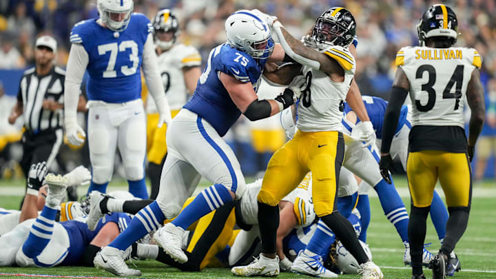 Indianapolis Colts guard Will Fries (75) and Pittsburgh Steelers linebacker Mykal Walker (38) tangle after a play Saturday, Dec. 16, 2023, during a game against the Pittsburgh Steelers at Lucas Oil Stadium in Indianapolis.