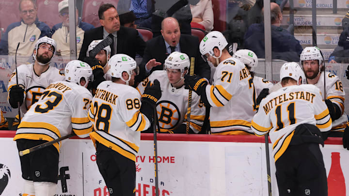 Apr 2, 2026; Sunrise, Florida, USA; Boston Bruins assistant coach Steve Spott speaks to Boston Bruins right wing David Pastrnak (88) during a timeout against the Florida Panthers in the third period at Amerant Bank Arena. Mandatory Credit: Sam Navarro-Imagn Images