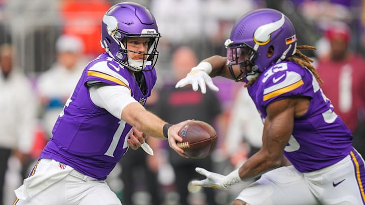 Dec 1, 2024; Minneapolis, Minnesota, USA; Minnesota Vikings quarterback Sam Darnold (14) hands the ball off to running back Aaron Jones (33) against the Arizona Cardinals in the first quarter at U.S. Bank Stadium. Dec 1, 2024; Minneapolis, Minnesota, USA; Minnesota Vikings quarterback Sam Darnold (14) hands the ball off to running back Aaron Jones (33) against the Arizona Cardinals in the first quarter at U.S. Bank Stadium.