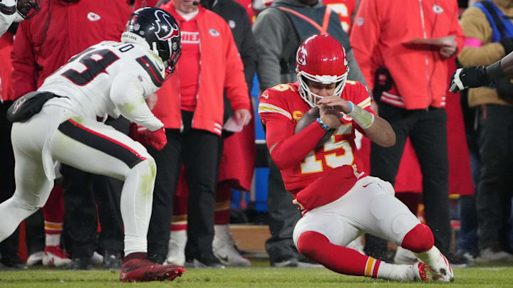 Jan 18, 2025; Kansas City, Missouri, USA; Kansas City Chiefs quarterback Patrick Mahomes (15) slides against Houston Texans linebacker Henry To'oTo'o (39) during the fourth quarter of a 2025 AFC divisional round game at GEHA Field at Arrowhead Stadium. Mandatory Credit: Denny Medley-Imagn Images