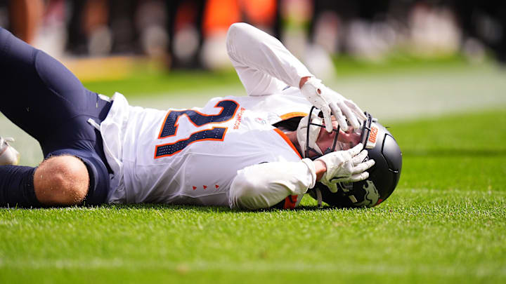 Sep 15, 2024; Denver, Colorado, USA; Denver Broncos cornerback Riley Moss (21) reacts to an injury after a tackle in the second quarter against the Pittsburgh Steelers at Empower Field at Mile High. 