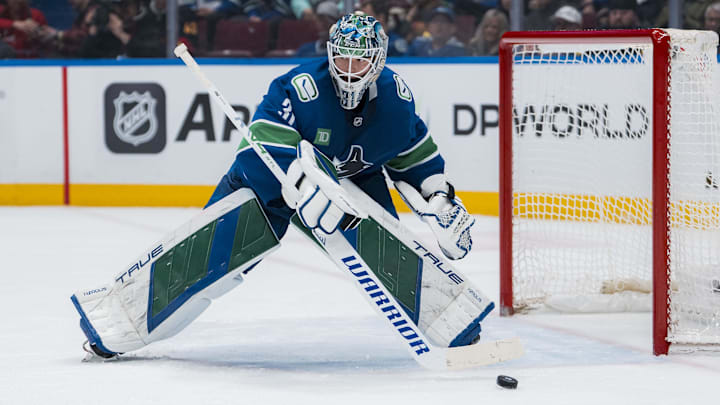 Mar 15, 2025; Vancouver, British Columbia, CAN; Vancouver Canucks goalie Arturs Silovs (31) handles the puck against the Chicago Blackhawks in the second period at Rogers Arena. Mandatory Credit: Bob Frid-Imagn Images