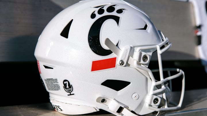 Oct 18, 2025; Stillwater, Oklahoma, USA; Cincinnati Bearcats helmet sits on the bench prior to the game against the Oklahoma State Cowboys at Boone Pickens Stadium. Mandatory Credit: William Purnell-Imagn Images
