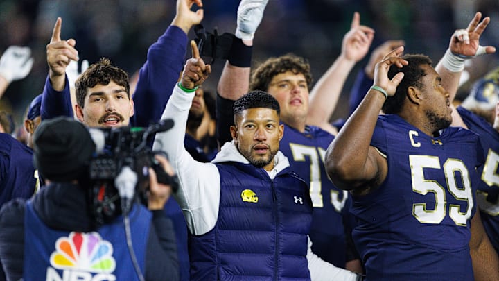 Notre Dame head coach Marcus Freeman celebrates with his players after winning a NCAA football game 70-7 against Syracuse at Notre Dame Stadium on Saturday, Nov. 22, 2025, in South Bend.