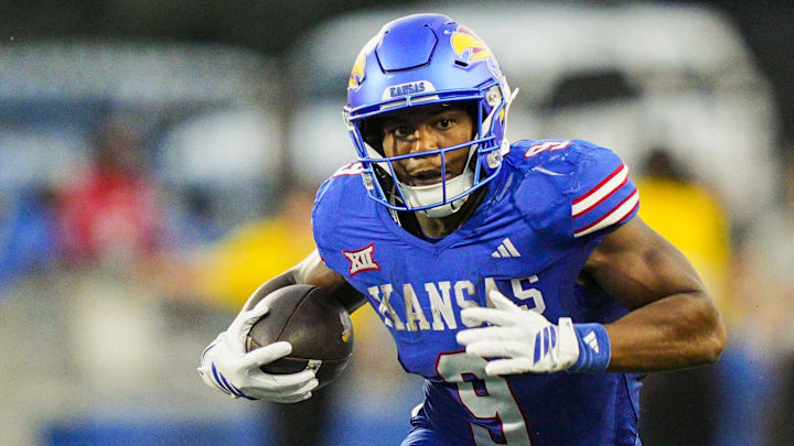 Aug 23, 2025; Lawrence, Kansas, USA; Kansas Jayhawks running back Daniel Hishaw Jr. (9) runs the ball during the second half against the Fresno State Bulldogs at David Booth Kansas Memorial Stadium. Mandatory Credit: Jay Biggerstaff-Imagn Images