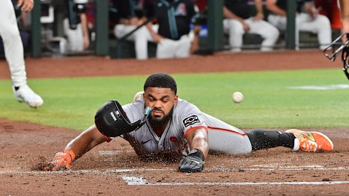 Sep 23, 2024; Phoenix, Arizona, USA;  San Francisco Giants outfielder Heliot Ramos (17) scores during the third inning against the Arizona Diamondbacks at Chase Field. 
