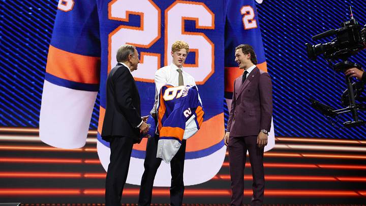 Jun 26, 2026; Buffalo, New York, USA; Malte Gustafsson reacts beside NHL commissioner Gary Bettman and New York Islanders player Matthew Schaefer after being selected with the thirteenth pick in the first round of the 2026 NHL Draft by the Islanders at KeyBank Center. Mandatory Credit: Timothy T. Ludwig-Imagn Images