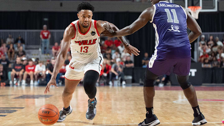 The Ville's David Johnson (13) makes his way around Sideline Cancer's Marcellus Earlington (11) during their game on Monday, July 22, 2024 in Louisville, Ky. at Freedom Hall during the second round of The Basketball Tournament. The Ville's David Johnson (13) makes his way around Sideline Cancer's Marcellus Earlington (11) during their game on Monday, July 22, 2024 in Louisville, Ky. at Freedom Hall during the second round of The Basketball Tournament.