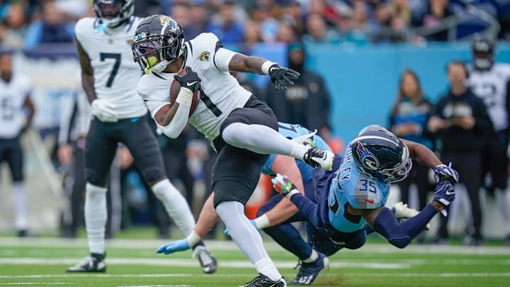 Jacksonville Jaguars running back Travis Etienne Jr. (1) eludes Tennessee Titans cornerback Daryl Worley (35) during the first quarter at Nissan Stadium in Nashville, Tenn., Sunday, Dec. 8, 2024.