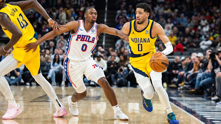 Jan 18, 2025; Indianapolis, Indiana, USA; Indiana Pacers guard Tyrese Haliburton (0) dribbles the ball while Philadelphia 76ers guard Tyrese Maxey (0) defends in the first half at Gainbridge Fieldhouse. Mandatory Credit: Trevor Ruszkowski-Imagn Images
