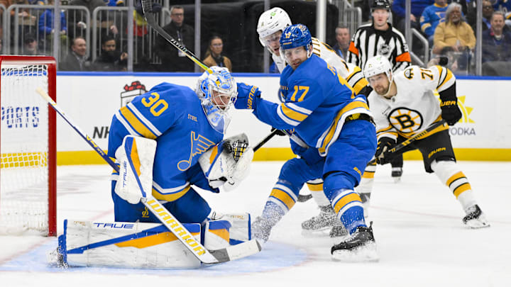 Dec 9, 2025; St. Louis, Missouri, USA; St. Louis Blues goaltender Joel Hofer (30) and defenseman Cam Fowler (17) defend the net against Boston Bruins center Casey Mittelstadt (11) during the first period at Enterprise Center. Mandatory Credit: Jeff Curry-Imagn Images Dec 9, 2025; St. Louis, Missouri, USA; St. Louis Blues goaltender Joel Hofer (30) and defenseman Cam Fowler (17) defend the net against Boston Bruins center Casey Mittelstadt (11) during the first period at Enterprise Center. Mandatory Credit: Jeff Curry-Imagn Images