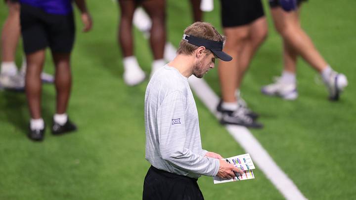 Kansas State coach Collin Klein looks at notes during practice at Kansas State University on Aug. 18, 2026. Kansas State coach Collin Klein looks at notes during practice at Kansas State University on Aug. 18, 2026.