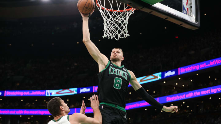 Nov 22, 2023; Boston, Massachusetts, USA; Boston Celtics center Kristaps Porzingis (8) dunks the ball vs. the Milwaukee Bucks.