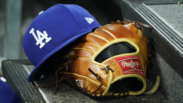 Apr 28, 2024; Toronto, Ontario, CAN; A hat and glove of an Los Angeles Dodgers player durng a game against the Toronto Blue Jays at Rogers Centre. Mandatory Credit: John E. Sokolowski-Imagn Images