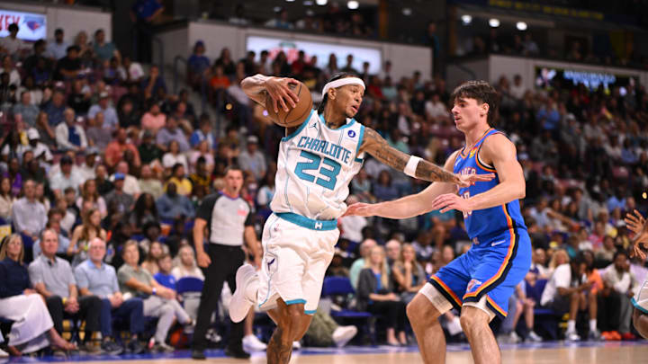 Oct 5, 2025; North Charleston, South Carolina, USA; Charlotte Hornets guard Tre Mann (23) grabs and guards the rebound against the Oklahoma City Thunder in the first quarter at North Charleston Coliseum. Mandatory Credit: Arthur Ellis-Imagn Images