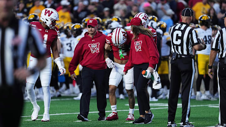 Oct 11, 2025; Madison, Wisconsin, USA; Wisconsin Badgers wide receiver Trech Kekahuna (2) is helped off the field after an injury during the first quarter against the Iowa Hawkeyes at Camp Randall Stadium. Mandatory Credit: Ross Harried-Imagn Images Oct 11, 2025; Madison, Wisconsin, USA; Wisconsin Badgers wide receiver Trech Kekahuna (2) is helped off the field after an injury during the first quarter against the Iowa Hawkeyes at Camp Randall Stadium. Mandatory Credit: Ross Harried-Imagn Images