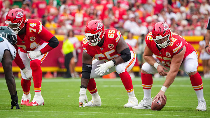 Sep 14, 2025; Kansas City, Missouri, USA; Kansas City Chiefs offensive tackle Jawaan Taylor (74) and guard Trey Smith (65) and center Creed Humphrey (52) at the line of scrimmage against the Philadelphia Eagles during the game at GEHA Field at Arrowhead Stadium. Mandatory Credit: Denny Medley-Imagn Images