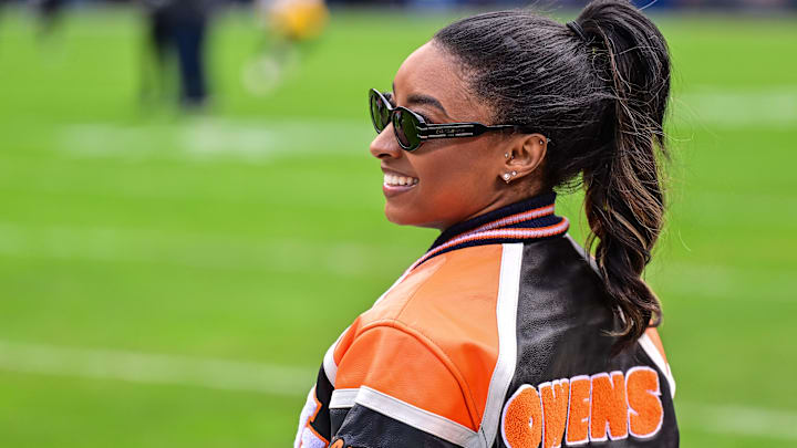 Simone Biles poses for a photo before the game between the Chicago Bears and Green Bay Packers at Soldier Field.