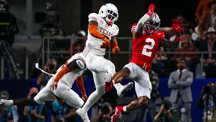 Ohio State receiver Emeka Egbuka (2) has a catch broken up by Texas Longhorns defensive back Jahdae Barron (7) during the College Football Playoff semifinal game in the Cotton Bowl at AT&T Stadium on Friday, Jan. 10, 2024 in Arlington, Texas. Ohio State receiver Emeka Egbuka (2) has a catch broken up by Texas Longhorns defensive back Jahdae Barron (7) during the College Football Playoff semifinal game in the Cotton Bowl at AT&T Stadium on Friday, Jan. 10, 2024 in Arlington, Texas.