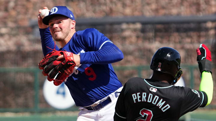Mar 10, 2024; Phoenix, Arizona, USA; Los Angeles Dodgers shortstop Gavin Lux (9) throws to first