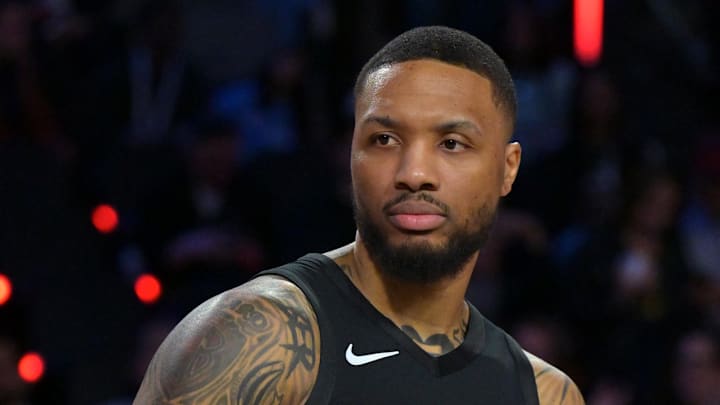 Portland Trail Blazers guard Damian Lillard celebrates with the trophy after winning the three point contest.