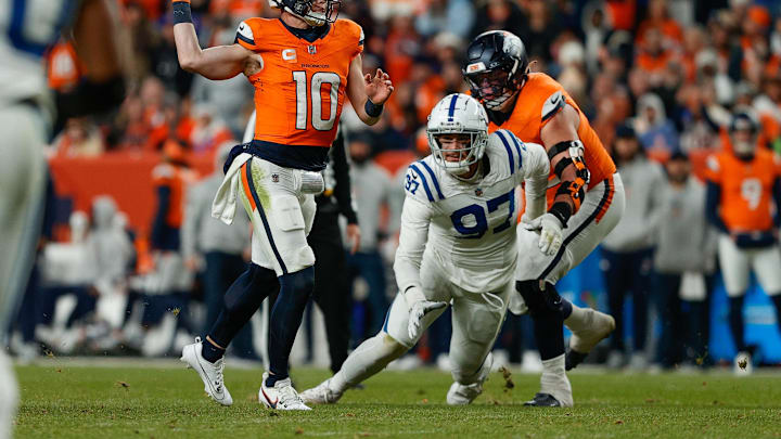 Dec 15, 2024; Denver, Colorado, USA; Denver Broncos quarterback Bo Nix (10) throws for a touchdown against Indianapolis Colts defensive end Laiatu Latu (97) as offensive tackle Garett Bolles (72) defends in the fourth quarter at Empower Field at Mile High. Mandatory Credit: Isaiah J. Downing-Imagn Images