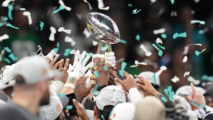Feb 9, 2025; New Orleans, LA, USA; The Philadelphia Eagles hoist the Vince Lombardi Trophy after defeating the Kansas City Chiefs in Super Bowl LIX at Ceasars Superdome. Mandatory Credit: Kirby Lee-Imagn Images