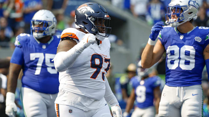 Sep 8, 2024; Seattle, Washington, USA; Denver Broncos defensive tackle D.J. Jones (93) celebrates a holding penalty against Seattle Seahawks guard Anthony Bradford (75) for a safety during the second quarter at Lumen Field. 